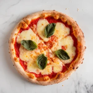 Close-up top-down view of crispy gluten free pizza with melted cheese and basil on a light background