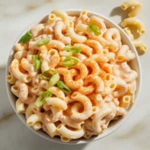Creamy Hawaiian macaroni salad in a bowl with green onions and paprika