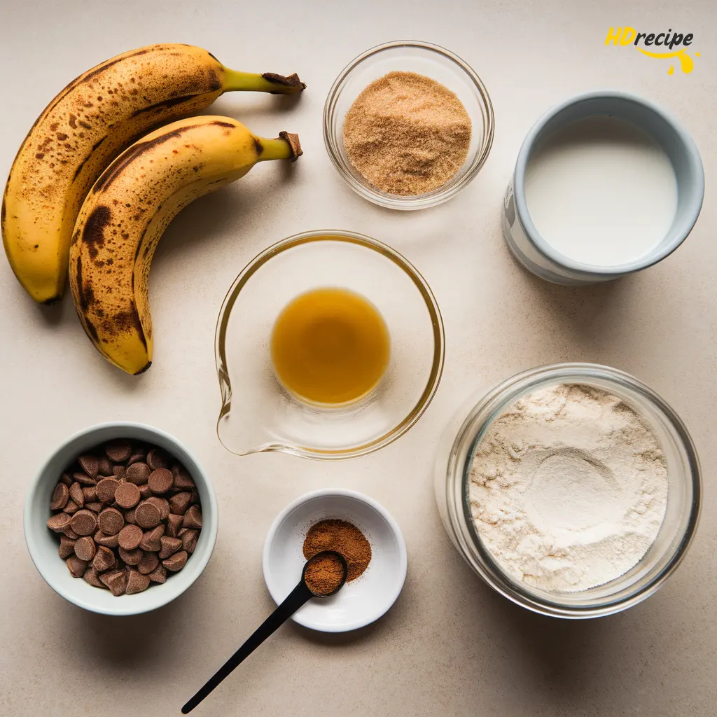 vegan-banana-bread-ingredients-flatlay Flat lay of vegan banana bread ingredients including ripe bananas, flour, sugar, oil, oat milk, and chocolate chips