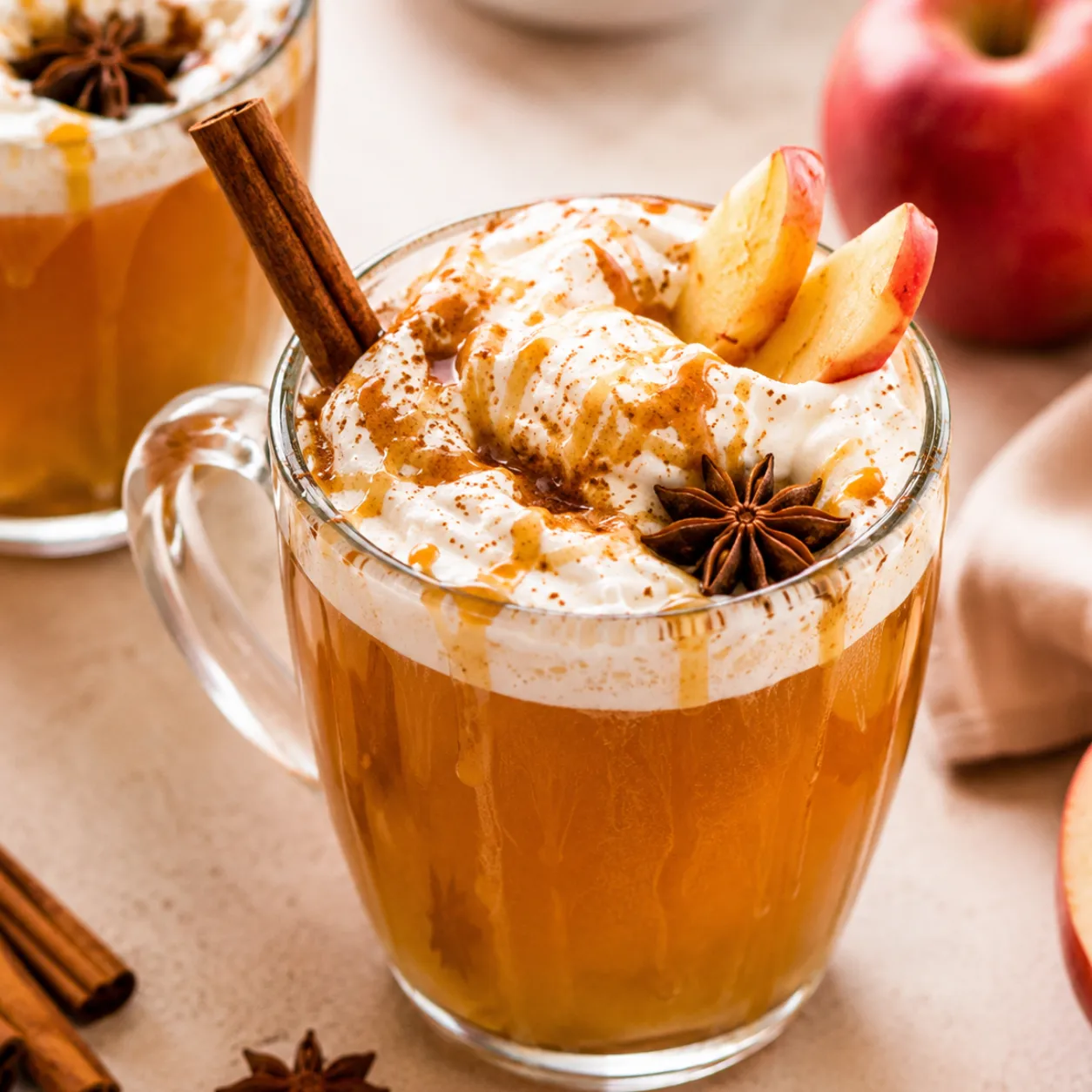 Overhead view of homemade spiced apple cider in a rustic mug with cinnamon stick and apple slice, cozy fall drink, warm holiday beverage, and autumn comfort recipe