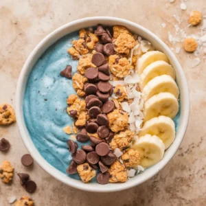 Cookie Monster smoothie bowl with blue base and cookie toppings